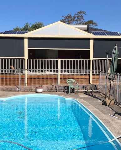 Outdoor zipscreen awning by a pool in Albion Park Rail, NSW